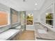 Bright bathroom with dual sinks, a glass-enclosed shower, and a soaking tub at 11889 N 113Th Pl, Scottsdale, AZ 85259