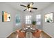 Cozy dining area with round table, seating for four, ceiling fan, and bright natural light at 11889 N 113Th Pl, Scottsdale, AZ 85259