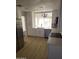 Bright kitchen featuring modern stainless steel appliances, white cabinetry and light wood floors at 11889 N 113Th Pl, Scottsdale, AZ 85259