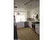Modern kitchen with stainless steel appliances, white cabinets, and a bright window over the sink at 11889 N 113Th Pl, Scottsdale, AZ 85259