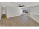 Open living room featuring wood floors, ceiling fan, and a bright window at 11889 N 113Th Pl, Scottsdale, AZ 85259