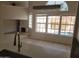 Open-concept living space with a contemporary chandelier, and backyard pool views at 11889 N 113Th Pl, Scottsdale, AZ 85259