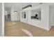 Elegant living room with a mirrored wall and view into the modern white kitchen at 11889 N 113Th Pl, Scottsdale, AZ 85259