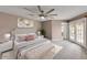 Spacious bedroom with a king bed, a ceiling fan, and access to the outdoor patio through french doors at 11889 N 113Th Pl, Scottsdale, AZ 85259