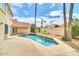 Inviting in-ground pool with a tanning deck, surrounded by lush landscaping and mature palm trees at 11889 N 113Th Pl, Scottsdale, AZ 85259