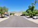 Quiet street view with well-maintained landscaping and a variety of parked cars in front of homes at 11889 N 113Th Pl, Scottsdale, AZ 85259