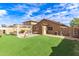 Turf backyard with block fencing, pergola, shed, and exterior home view at 12230 W Larkspur Rd, El Mirage, AZ 85335