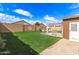 Turf backyard with perimeter block fencing, shed, pergola and gravel side yard at 12230 W Larkspur Rd, El Mirage, AZ 85335