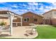 Turf backyard with pergola, patio, seating, and exterior home view at 12230 W Larkspur Rd, El Mirage, AZ 85335