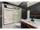 Bathroom featuring a vanity with sink, toilet, and shower with glass sliding doors at 12230 W Larkspur Rd, El Mirage, AZ 85335