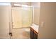 Bright bathroom with a shower-tub combo, neutral paint, and a single sink vanity at 12230 W Larkspur Rd, El Mirage, AZ 85335