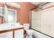 Bathroom featuring a vanity with sink, toilet, and shower with glass sliding doors at 12230 W Larkspur Rd, El Mirage, AZ 85335