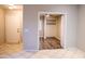 Bedroom hallway features a front door and view into a bedroom with a ceiling fan at 12230 W Larkspur Rd, El Mirage, AZ 85335