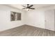 Bright bedroom with sleek plank flooring, a window, and closet at 12230 W Larkspur Rd, El Mirage, AZ 85335