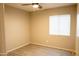 Bedroom features light wood floors, neutral paint, a ceiling fan and a window at 12230 W Larkspur Rd, El Mirage, AZ 85335