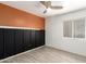 Neutral bedroom with ceiling fan, light gray floors and a black accent wall at 12230 W Larkspur Rd, El Mirage, AZ 85335