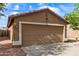 Close up of the garage showing the garage door at 12230 W Larkspur Rd, El Mirage, AZ 85335