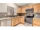 Upgraded kitchen featuring a stainless steel dishwasher, stove, microwave, and tile backsplash at 12230 W Larkspur Rd, El Mirage, AZ 85335