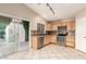 Spacious kitchen with tile flooring, stainless appliances, and a view of the backyard at 12230 W Larkspur Rd, El Mirage, AZ 85335