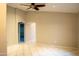 Spacious living room features a ceiling fan, neutral paint, tile floors and is ready for personalization at 12230 W Larkspur Rd, El Mirage, AZ 85335