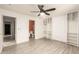 Open bedroom layout with plank floors and a glimpse into the en-suite bathroom at 12230 W Larkspur Rd, El Mirage, AZ 85335