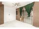 Sun room with ceiling fan, sliding glass doors with green curtains, and tile flooring at 12230 W Larkspur Rd, El Mirage, AZ 85335