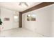 Enclosed sun room with ceiling fan, brick tile flooring, and exterior access at 12230 W Larkspur Rd, El Mirage, AZ 85335