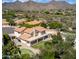 Aerial view showcases a pristine backyard featuring a putting green, covered patio and desert landscaping at 12853 E Yucca St, Scottsdale, AZ 85259