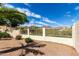 Backyard view of desert landscaping with white fencing at 12853 E Yucca St, Scottsdale, AZ 85259