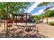 Backyard area with desert landscaping, a pergola, a pool, and palm trees at 12853 E Yucca St, Scottsdale, AZ 85259