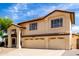 Charming two-story home featuring a red tile roof and a spacious three-car garage at 12853 E Yucca St, Scottsdale, AZ 85259