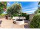 Backyard hardscape featuring a beautiful brick fire pit with built in seating and desert landscaping at 12853 E Yucca St, Scottsdale, AZ 85259