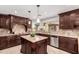 Gourmet kitchen features dark wood cabinetry, granite counters, stainless appliances, and island at 12853 E Yucca St, Scottsdale, AZ 85259