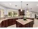 Gourmet kitchen features dark wood cabinetry, granite counters, stainless appliances, and island at 12853 E Yucca St, Scottsdale, AZ 85259