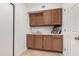 Functional laundry room with built-in cabinets, sink and countertop, perfect for chores at 12853 E Yucca St, Scottsdale, AZ 85259