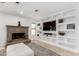 Relaxing living room with a brick fireplace and custom built in shelving at 12853 E Yucca St, Scottsdale, AZ 85259