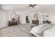 Spacious main bedroom featuring a ceiling fan, carpet flooring, and large windows offering bright, natural light at 12853 E Yucca St, Scottsdale, AZ 85259