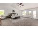 Spacious main bedroom featuring a ceiling fan, carpet flooring, and large windows offering bright, natural light at 12853 E Yucca St, Scottsdale, AZ 85259