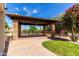 Outdoor pergola with stone pillars and a wooden deck in a landscaped backyard at 12853 E Yucca St, Scottsdale, AZ 85259
