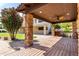 Outdoor pergola with stone pillars and a wooden deck adds to the backyard space at 12853 E Yucca St, Scottsdale, AZ 85259