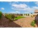 Beautiful backyard with artificial turf, a cozy fire pit, desert landscaping, and string lights at 13228 W Buckskin Trl, Peoria, AZ 85383