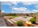 Landscaped backyard with gravel, pavers, artificial turf, fire pit, and string lights for outdoor living at 13228 W Buckskin Trl, Peoria, AZ 85383