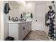 Bathroom with double vanity, matte black faucets, and decorative tile flooring at 13228 W Buckskin Trl, Peoria, AZ 85383
