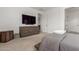 Spacious bedroom featuring a large TV above a dresser with view to hall and doorway at 13228 W Buckskin Trl, Peoria, AZ 85383