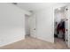 Empty carpeted bedroom leading to closet and other rooms at 13228 W Buckskin Trl, Peoria, AZ 85383