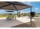Covered picnic and BBQ area in a well-maintained community park with playground and landscaping at 13228 W Buckskin Trl, Peoria, AZ 85383
