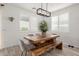 Stylish dining area featuring a rustic wood table, bench seating, and modern light fixture at 13228 W Buckskin Trl, Peoria, AZ 85383