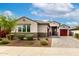 Inviting single-story home with a well-manicured front yard and a three-car garage at 13228 W Buckskin Trl, Peoria, AZ 85383