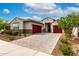 Charming single-story home with a three-car garage, paver driveway, and well-maintained desert landscaping at 13228 W Buckskin Trl, Peoria, AZ 85383