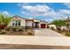 Single-story home with three-car garage and drought-resistant landscaping at 13228 W Buckskin Trl, Peoria, AZ 85383